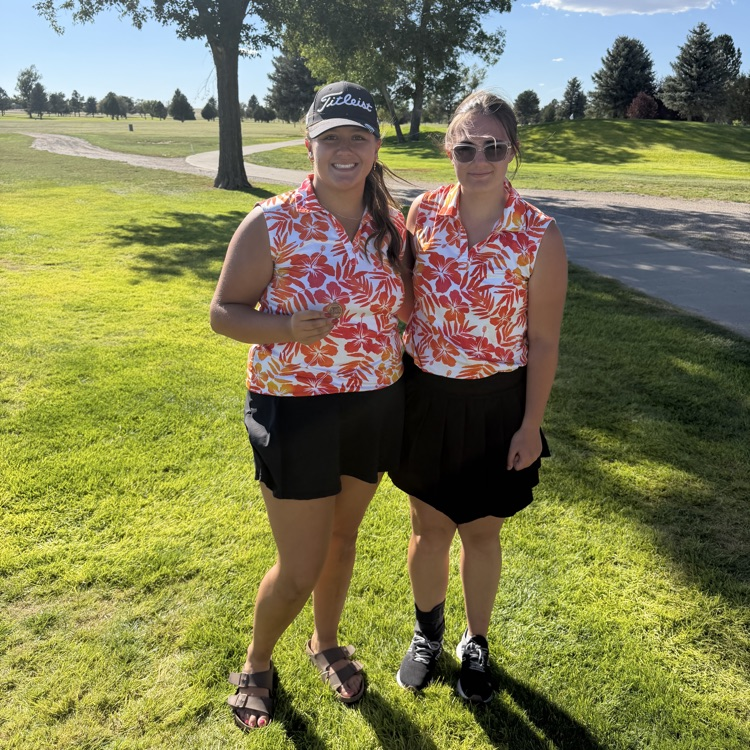 golfers holding medals