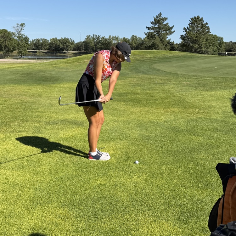 golfer chipping toward green