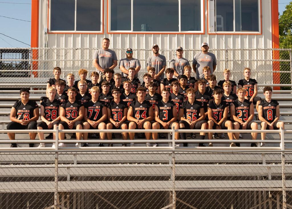 ogallala football team sitting on bleachers posing for a team picture