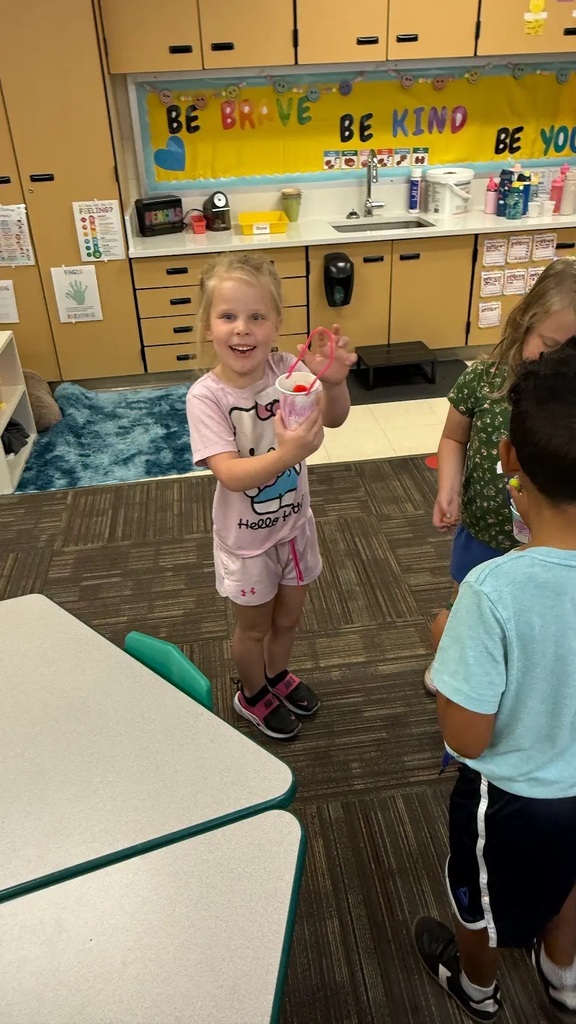student smiling holding bucket