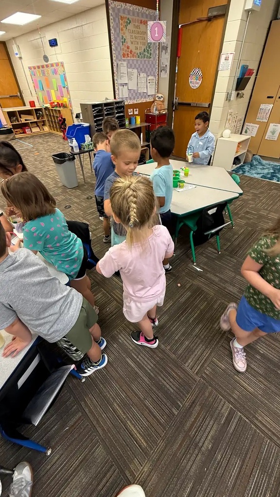 students walking around classroom