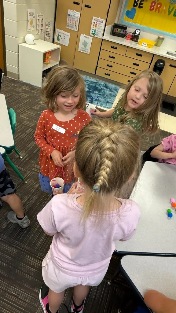students holding buckets and talking to each other
