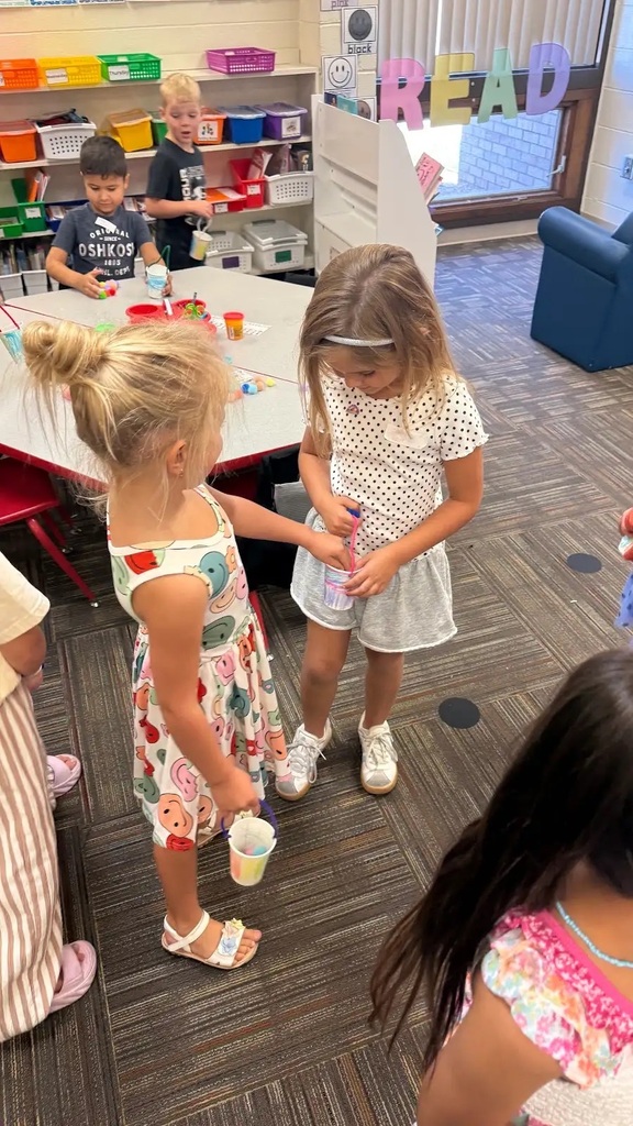 students holding buckets