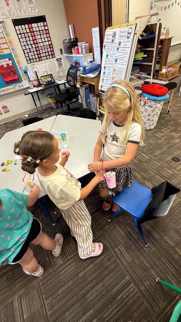 students holding buckets
