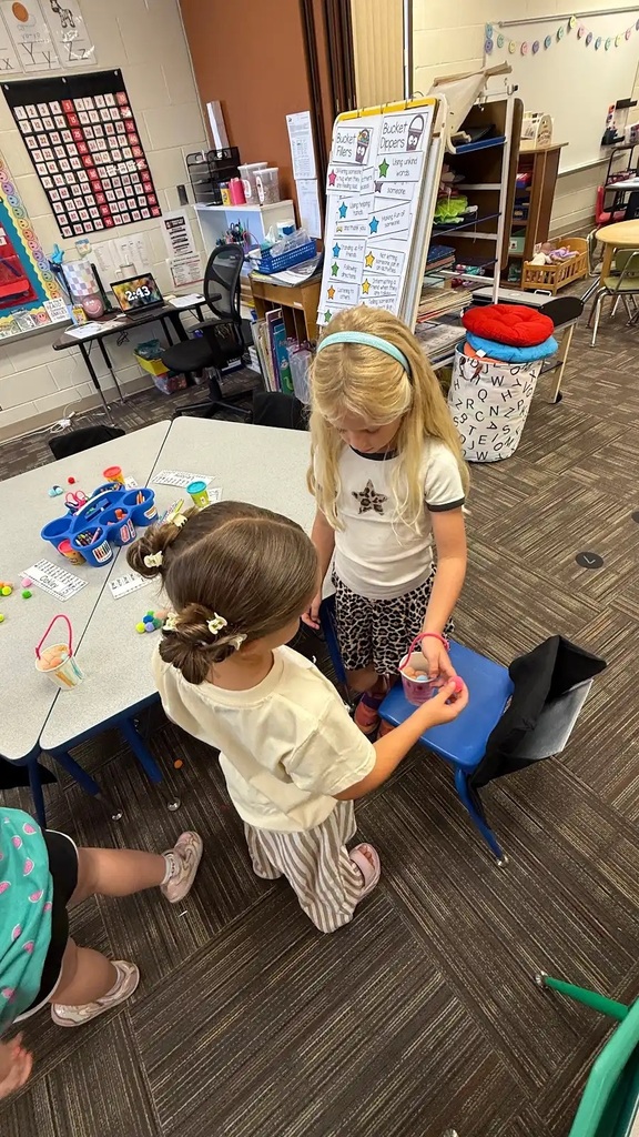 students holding buckets