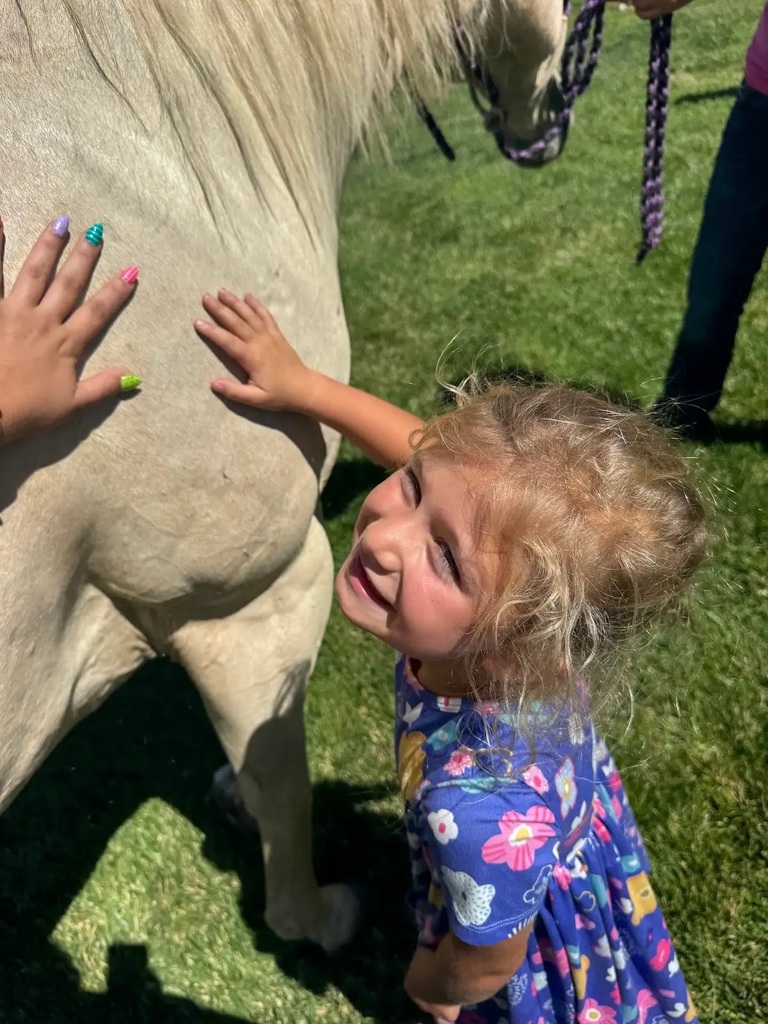 student petting horse