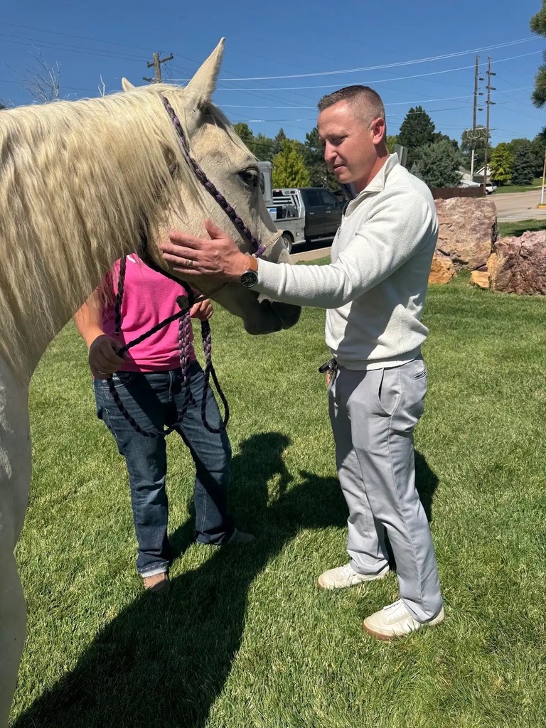adult man petting horse