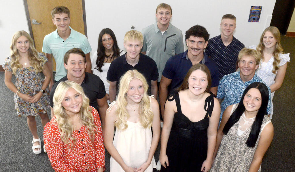 group of students looking up at camera smiling