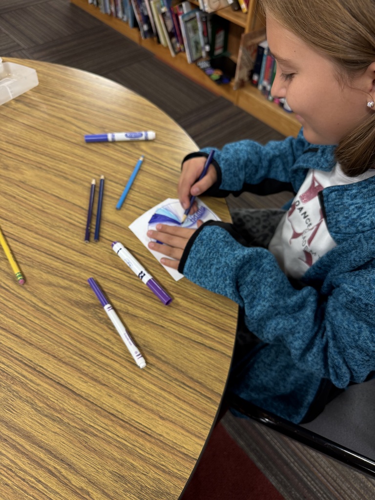 student shading a dot with a purple colored pencil