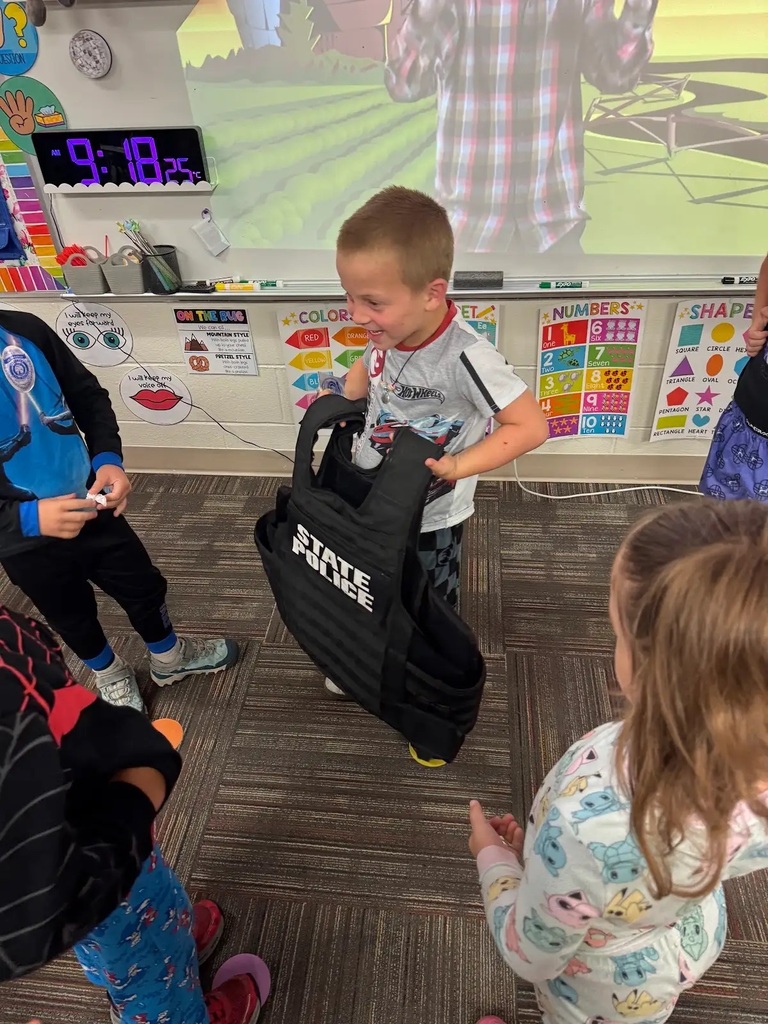 student holding a black state patrol vest