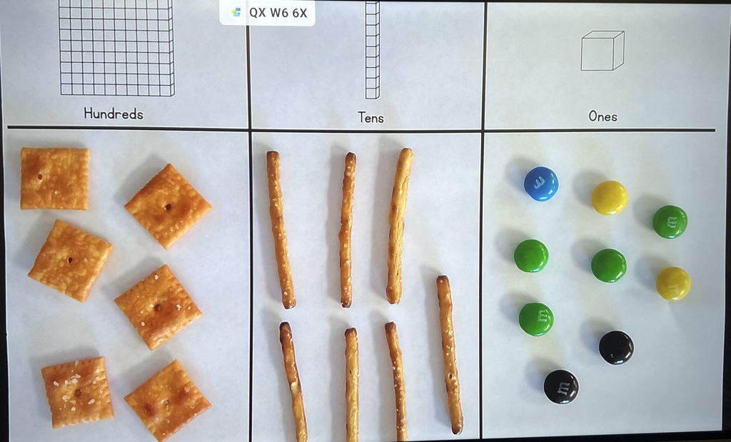 place value worksheet with snacks layign on it
