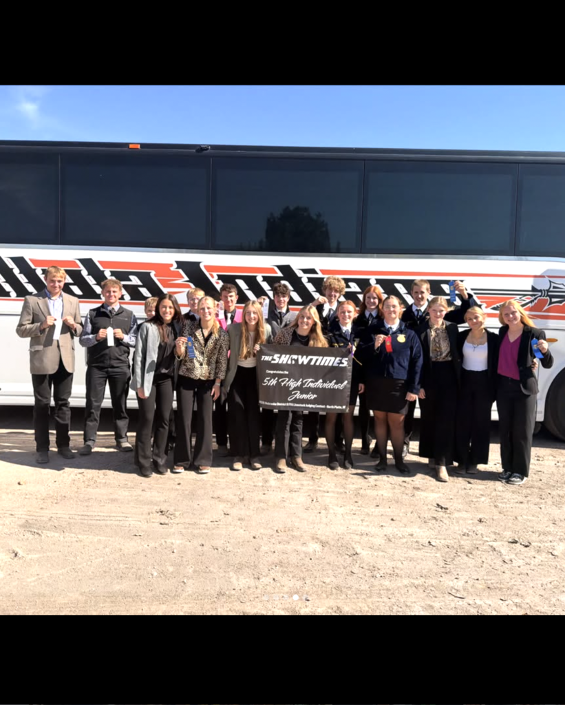 ffa students holding ribbons and sign standing in front of bus