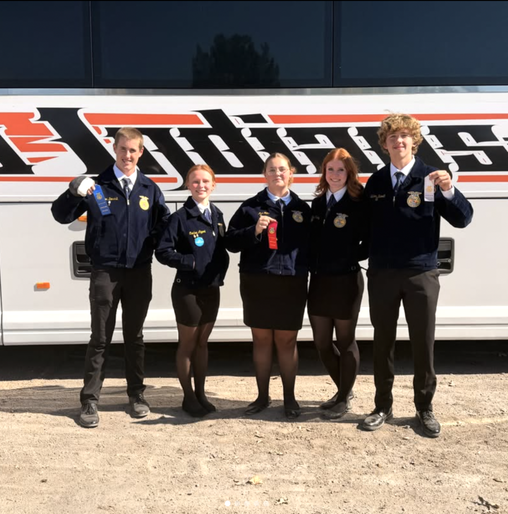 ffa students holding ribbons standing in front of bus