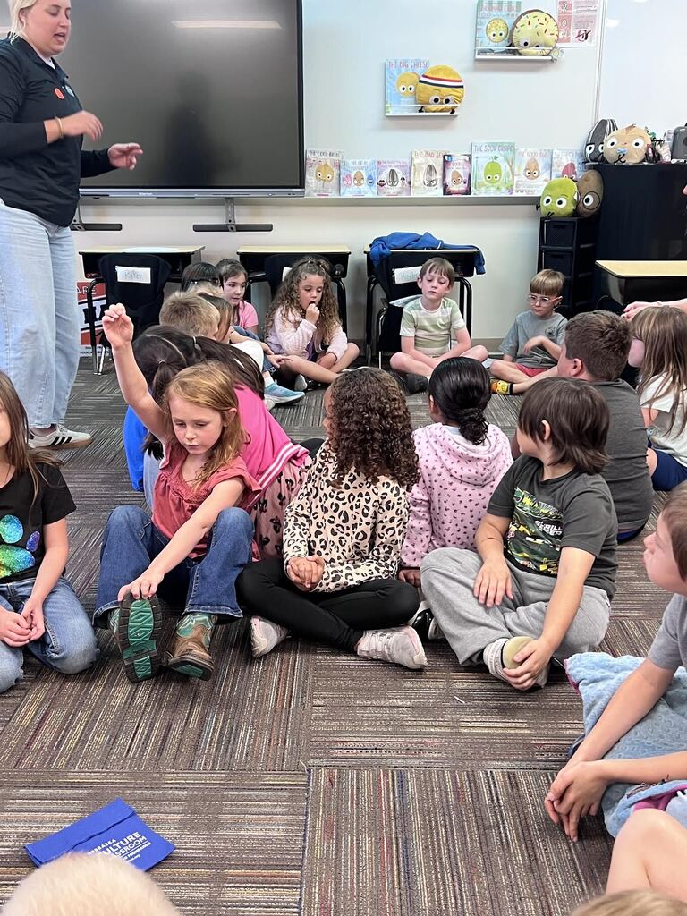 students sitting in a circle on the carpet organizing dots
