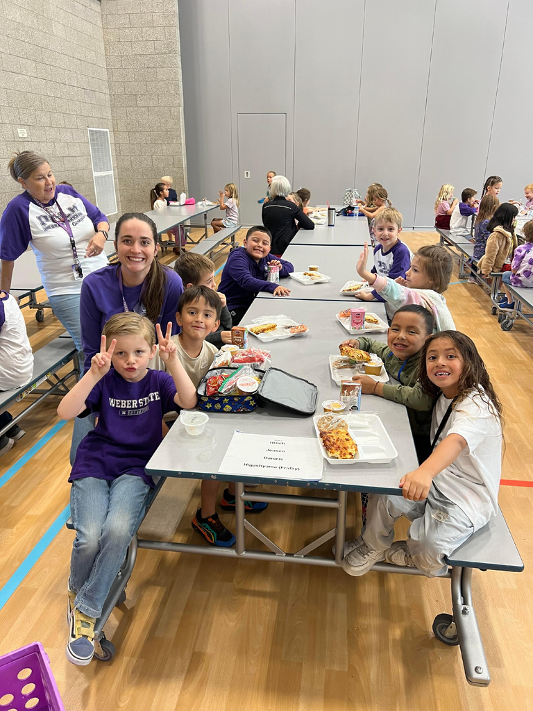 Students sitting at lunch tables eating