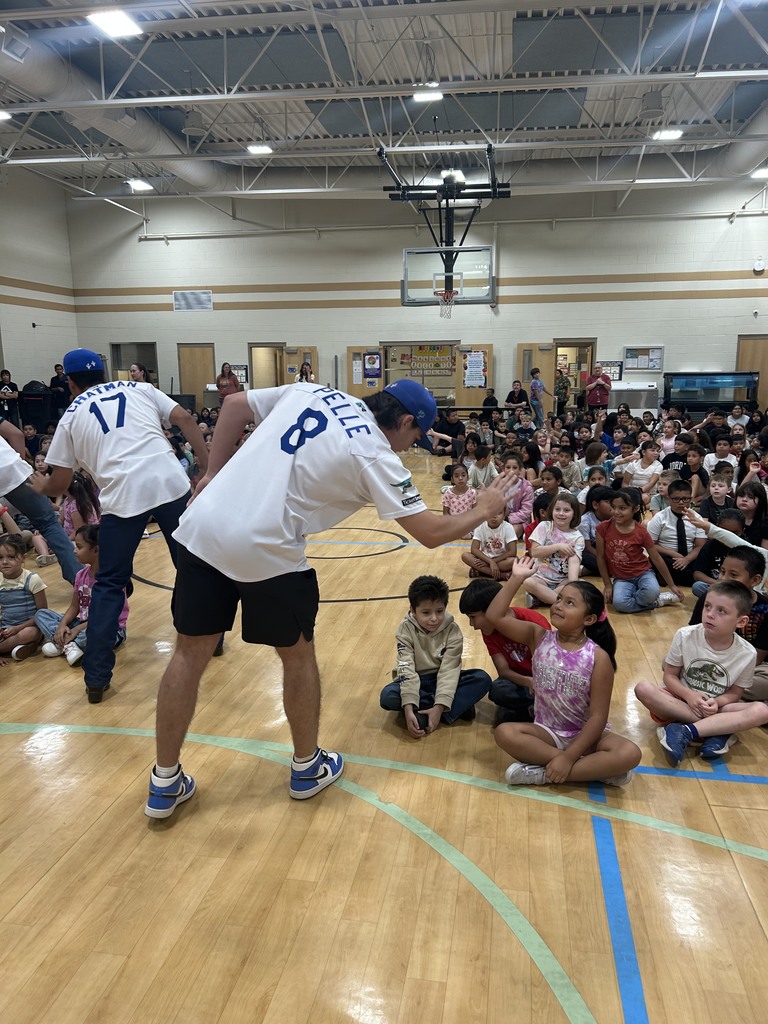 Raptors players high five with students