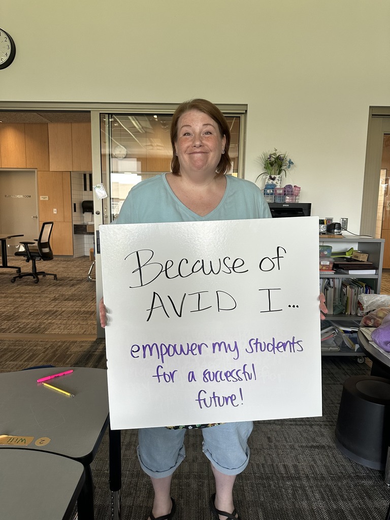 Teacher with AVID Sign