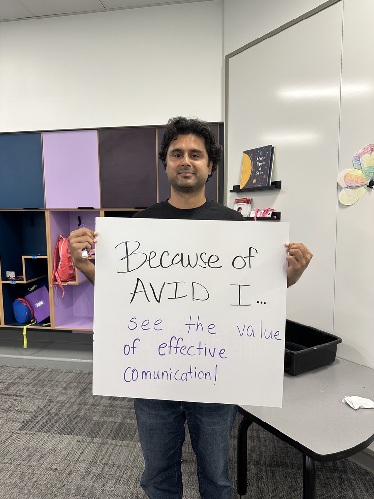 Teacher with AVID sign
