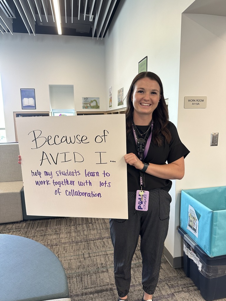 Teacher with AVID sign