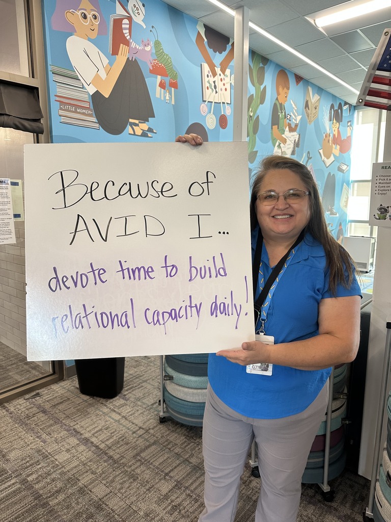 Teacher with their AVID sign