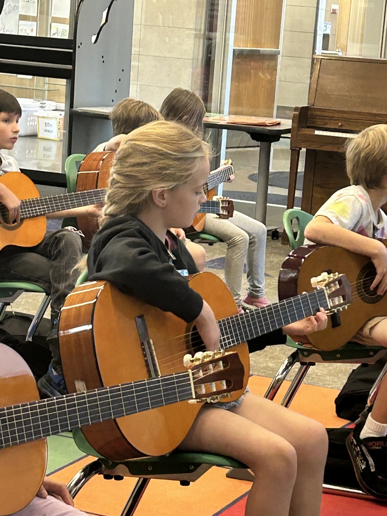 Kids with guitars in music class