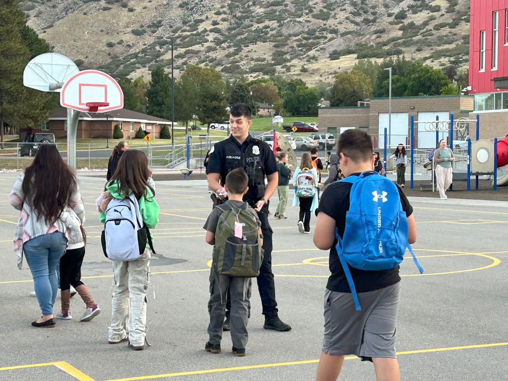 kid talking with police officer