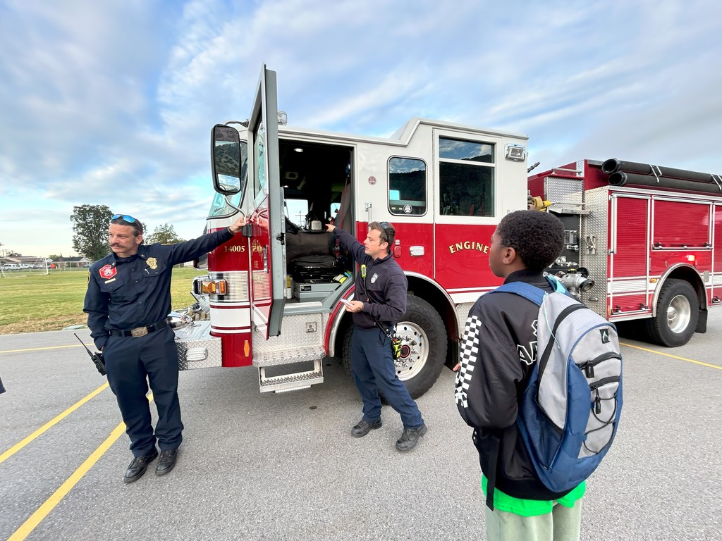 kid looking at firetruck