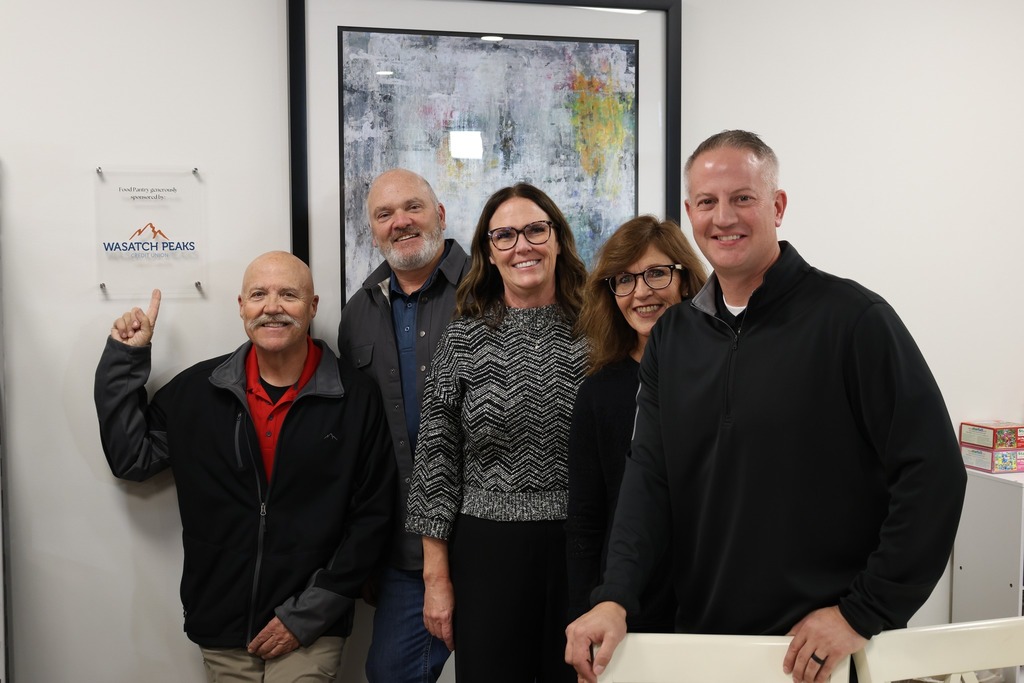 Wasatch Peaks Team members by new pantry sign