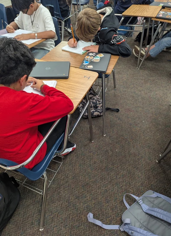 students working at desks in classroom