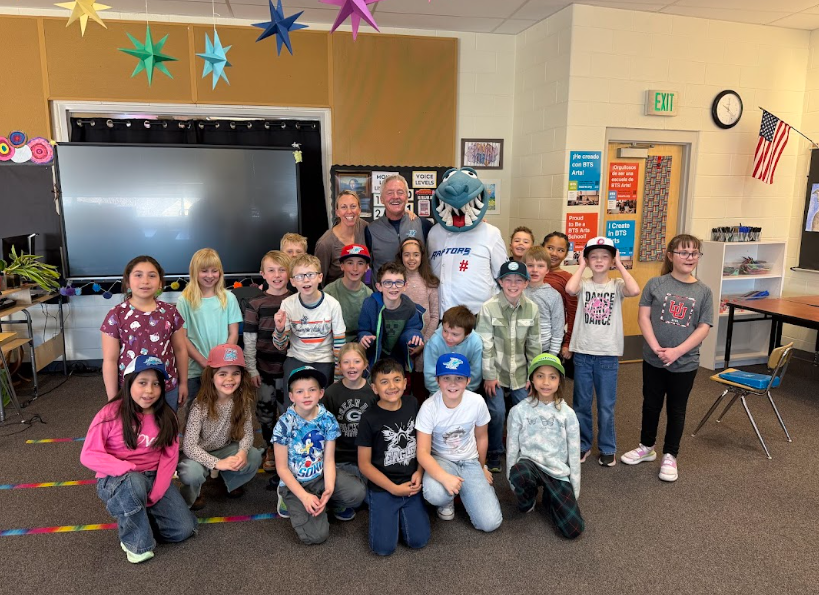Raptors mascot and team owner with elementary students