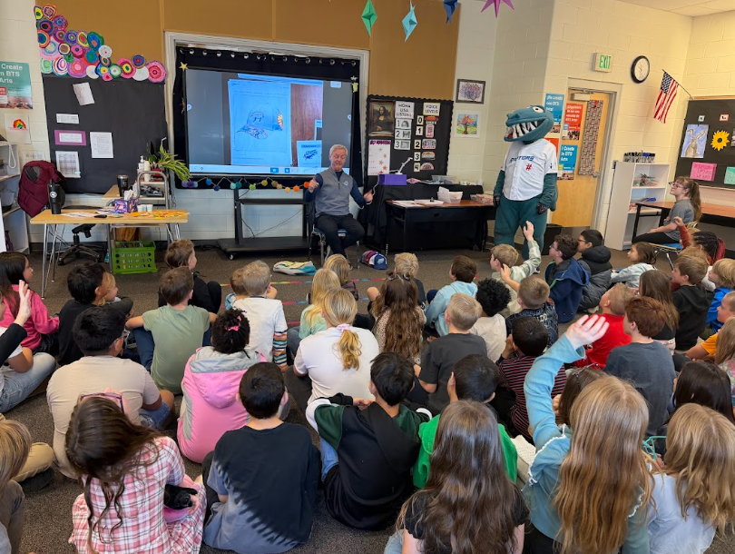 Raptors mascot and team owner in elementary classroom