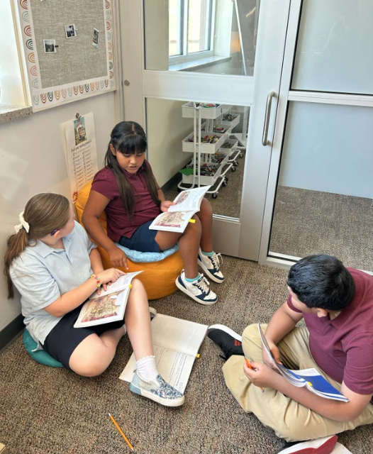 students reading books in flexible seating