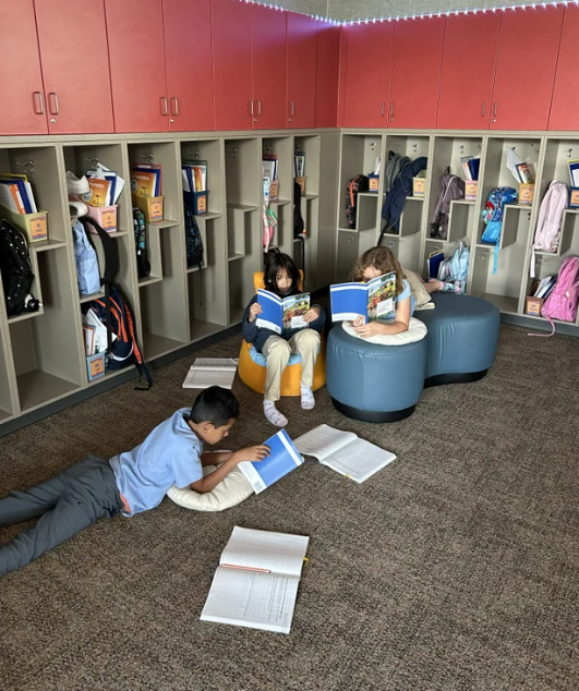 students reading books in flexible seating