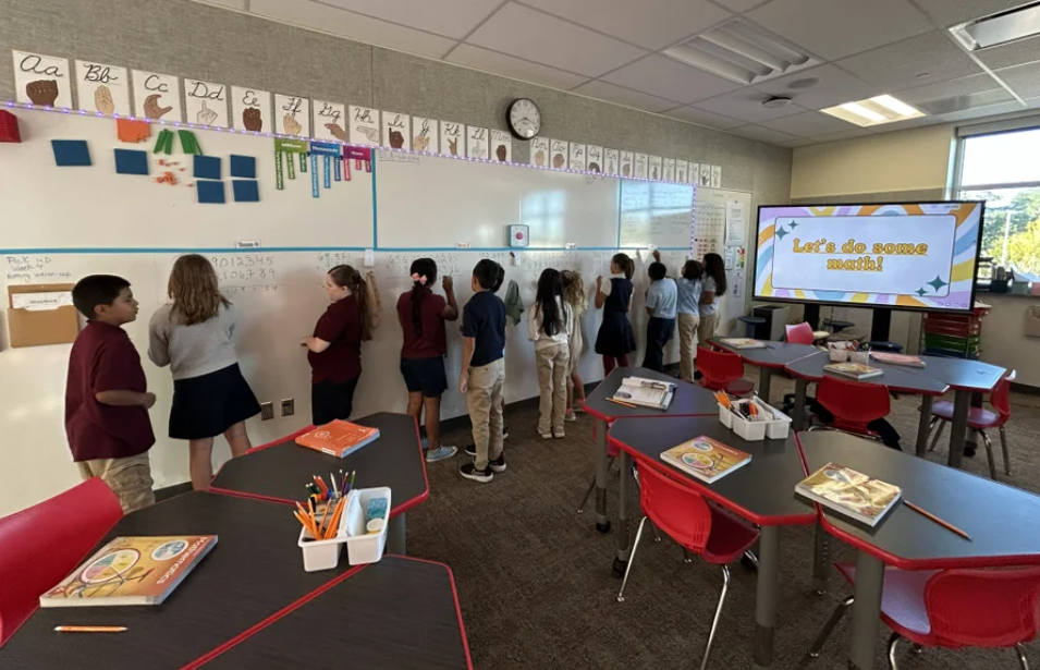 students at white board working on math equations