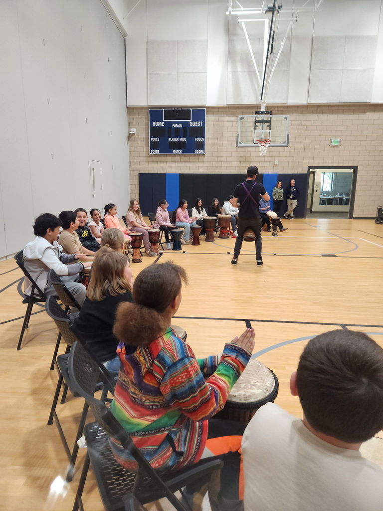 elementary students participating in drum circle