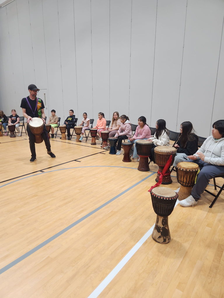 elementary students participating in drum circle