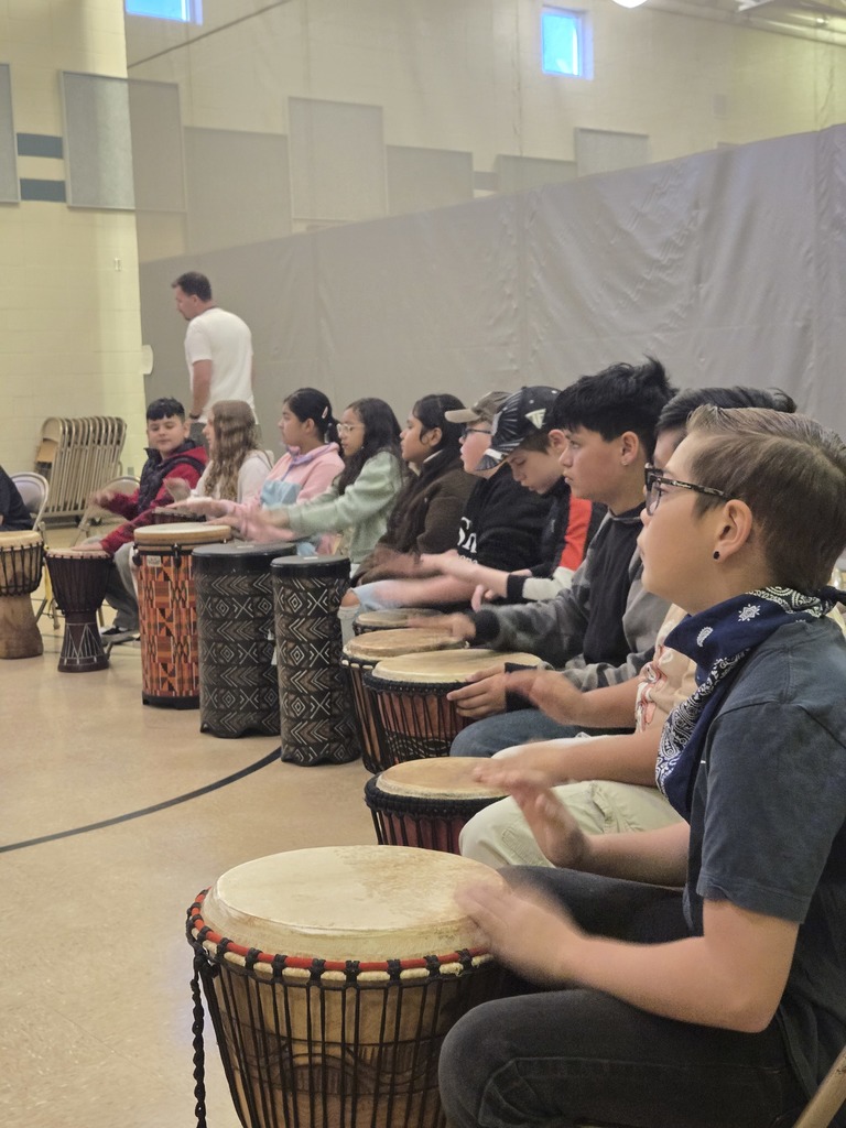 elementary students participating in drum circle
