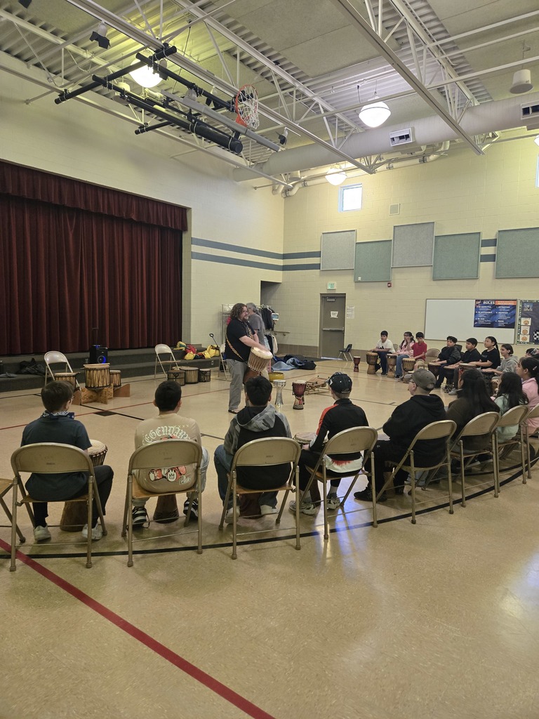 elementary students participating in drum circle