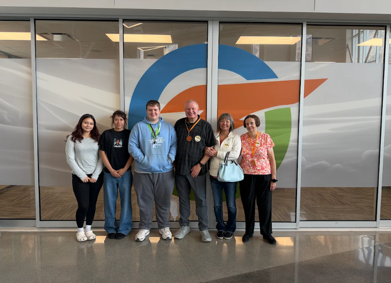 students at otech high with the powell foundation members