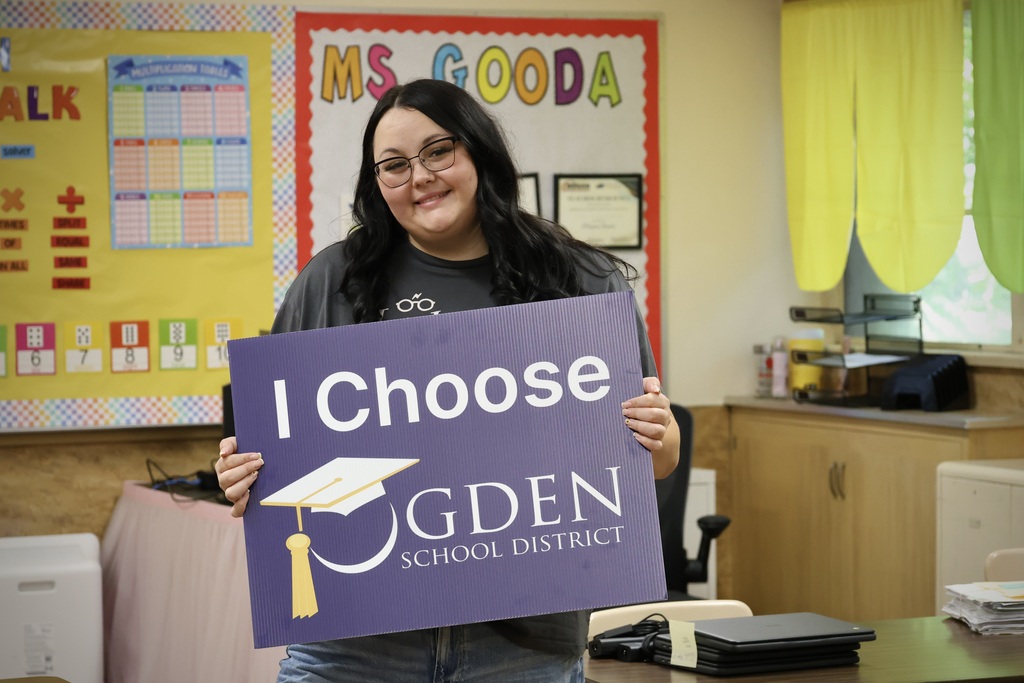 Teacher holding a sign