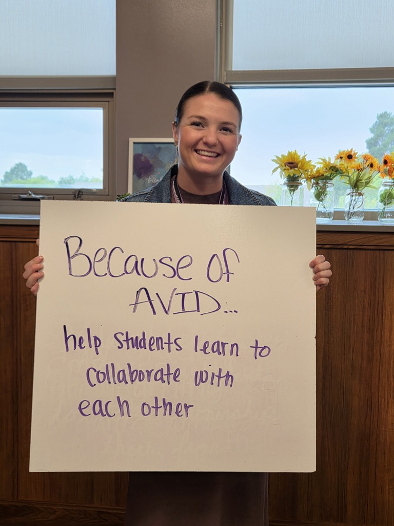 Teacher holding whiteboard with the answer about why they love AVID