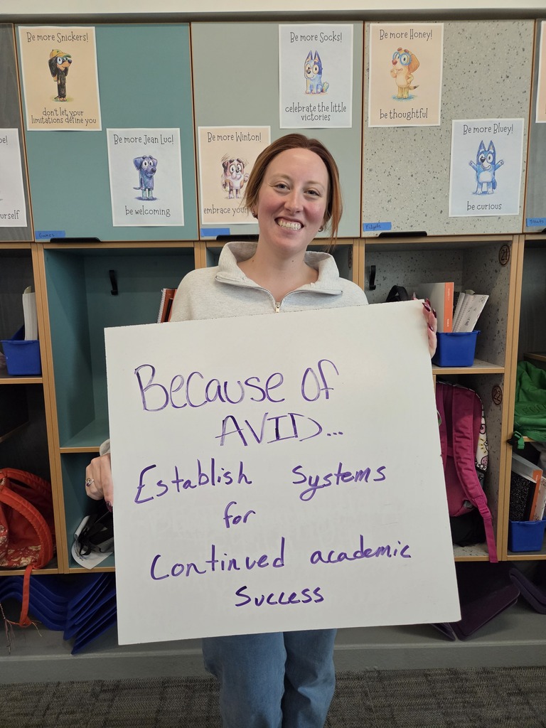 Teacher holding whiteboard about why they love AVID