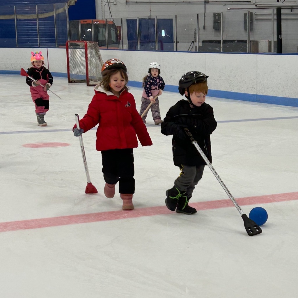 Two student playing together on the ice 