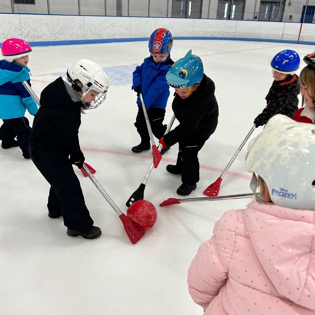 Group of student interacting together and playing on the ice 