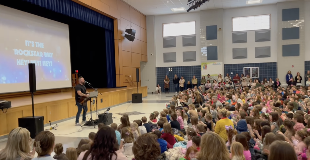 Musician Performing to a Large Group of Kids 