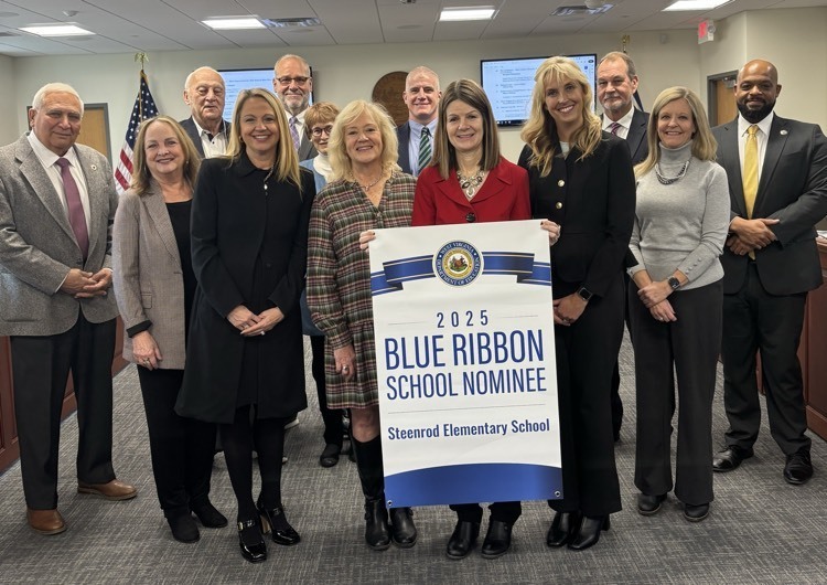 photo of school officials holding recognition sign