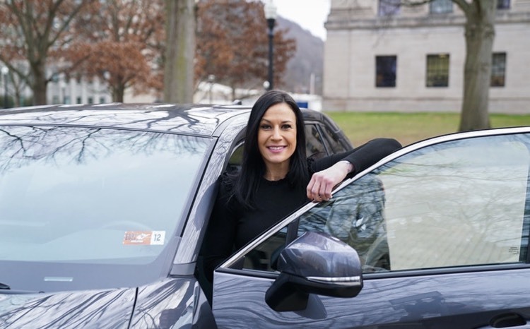 woman posing with car