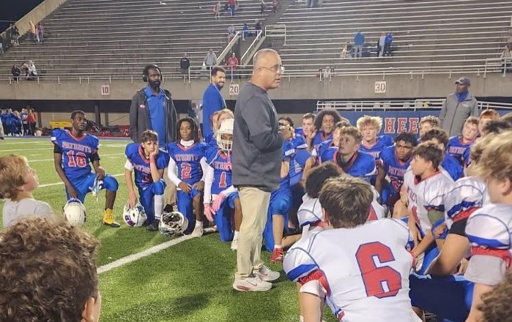 coach posing with students