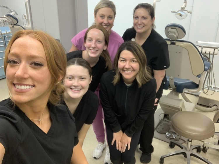 dentist posing with staff
