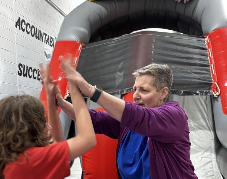 principal hi fives student 